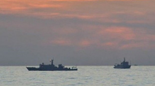 This undated handout photo taken by the Philippine Navy and released April 11, 2012, by the Department of Foreign Affairs shows Chinese surveillance ships off Panatag (Scarborough) Shoal. Armed Forces Chief of Staff Gen. Emmanuel Bautista on Monday, Feb. 24, 2014, accused China’s Coast Guard of firing water cannon at Filipino fishermen last month to drive them away from Panatag Shoal in the West Philippine Sea.  AFP FILE PHOTO/DFA/PN 