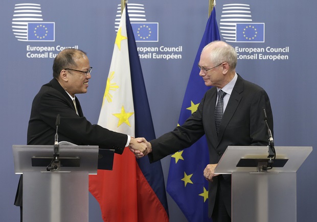 European Council President Herman Van Rompuy, right, shakes hands with Benigno Aquino III, President of the Phillippines, after they addressed the media at the European Council building in Brussels, Tuesday, Sept. 16, 2014. (AP Photo/Yves Logghe)