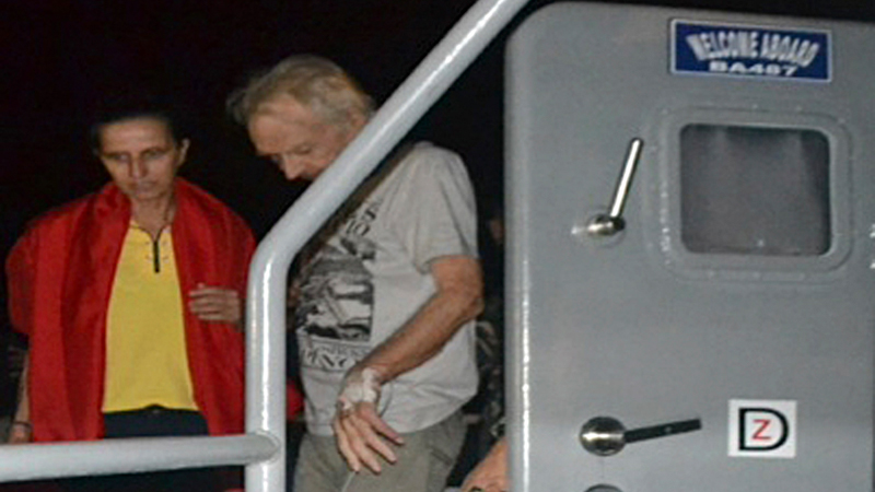 In this photo released by the Armed Forces of the Philippines, kidnapped German nationals Stefan Okonek, right, and female companion Henrike Dielen disembark from the Philippine Navy vessel upon arrival at dawn Saturday, Oct. 18, 2014, at the Western Mindanao Command in Zamboanga city in southern Philippines. Okonek and Dielen, who had been kidnapped and held for six months in the southern Philippines were released Friday by the militant group just hours after it had threatened to behead one of them if no ransom payment was made, the Philippine defense chief said. (AP Photo/Armed Forces of the Philippines Western Mindanao Command)
