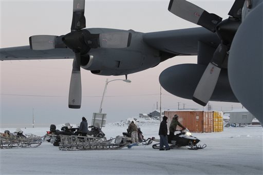 This photo taken Dec. 6, 2014, shows Christmas toys and other supplies being loaded from a C130 military transport plane onto sleds being pulled by snowmobiles in Shishmaref, Alaska. The Alaska National Guard provided transport for the good Samaritan program Operation Santa, which took gifts and schools supplies to about 300 children in the Inupiat Eskimo community. AP