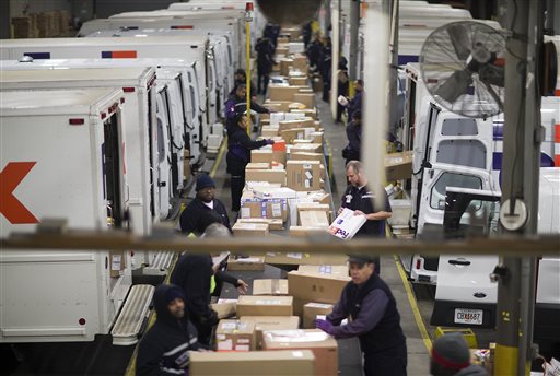 Packages are sorted on a conveyer belt before being loaded onto trucks for delivery at a FedEx facility, Monday, Dec. 15, 2014, in Marietta, Ga. With just ten days until Christmas, the delivery service is expecting a spike of packages as customers rush to get deliveries before the holiday. AP