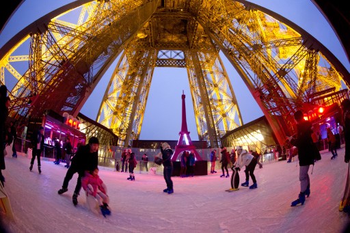 People skate on the ice rink hosted on the Eiffel Tower's first floor on December 15, 2014 in Paris. AFP 