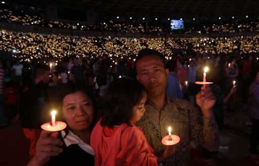 Worshippers take part in a Christmas service at Gelora Bung Karno Stadium in Jakarta, Indonesia, Saturday, Dec 13, 2014. AP
