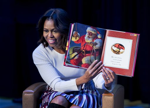 First lady Michelle Obama reads Twas the night before Christmas to patients, families, and staff at Childrens National Health System in Washington, Monday, Dec. 15, 2014. AP