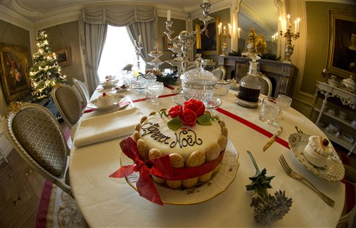 A cake reads Joyeux Noel or Merry Christmas in an arrangement of a 19th century Christmas dining table at Willet-Holthuysen Museum in Amsterdam, Netherlands, Tuesday, Dec. 9, 2014. The museum give the visitors a look into a 19th century fully furnished patrician house on Herengracht canal. AP