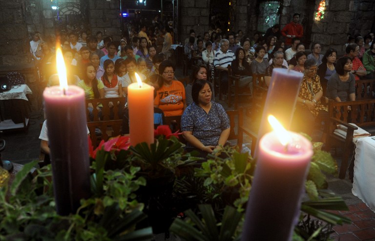 Filipinos attend the first of nine dawn masses signalling the official start of the Christmas at a Roman Catholic Church in Manila on December 16, 2014. The tradition of dawn masses dates back to the Spanish era, which culminates on Christmas Eve and it is a belief that anyone who completes the chain will have his wish granted.   AFP 