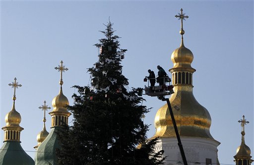 Workers decorate a New Year tree, in front of the St. Sophia Cathedral in central Kiev, Ukraine, Monday, Dec. 15, 2014. New Year is widely celebrated as the most popular holiday in Ukraine with the Orhodox Christmas being celebrated on Jan. 7. AP