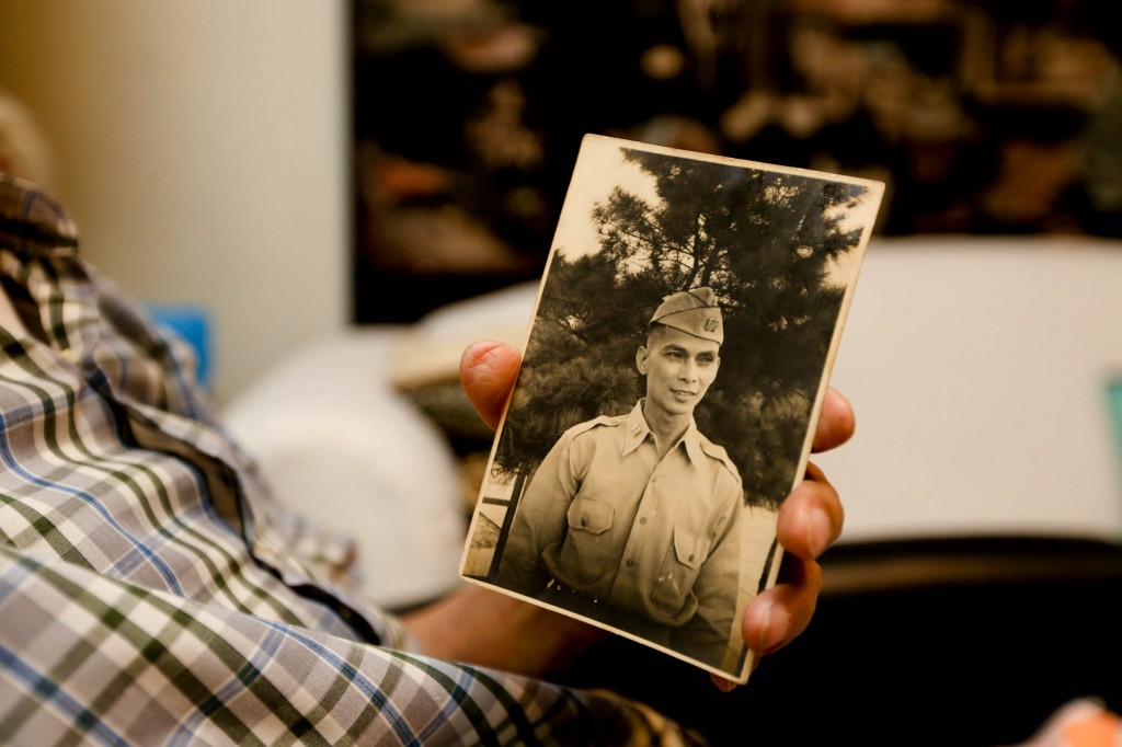 World War II veteran Dr. Jose Perez Javier, 105 years old, shows an old photo of himself in his youth. Javier was among those who survived the Death March.  INQUIRER PHOTO/LYN RILLON