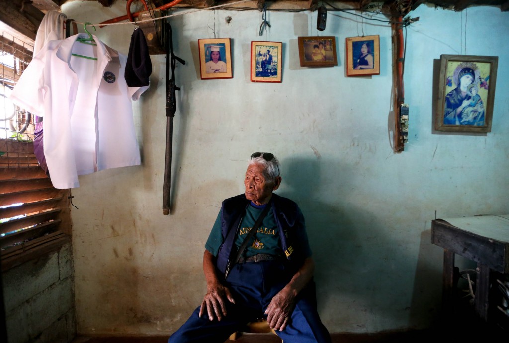 World War II veteran Alberto Solomon, 94 years old, inside his small house in Barangay Santolan, Pasig City. On the walls are old photos of some of his children and a nephew. At left is a "sibat" that his daughter Elena says he brings with him when he goes out. Mr. Solomon is physically fit for his age, but two of his grandsons still stay with him here to care for his needs. INQUIRER PHOTO/LYN RILLON