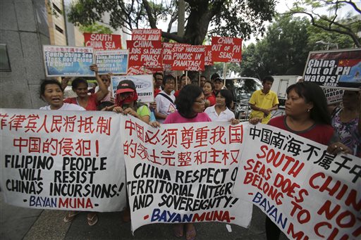 Filipino activists march towards the Chinese Consulate during an anti-China rally at the financial district of Makati, south of Manila, Philippines on Thursday, June 4, 2015. More than 100 Filipino activists demanded that China stop its increasingly assertive actions in the disputed South China Sea, and warned during a rally Thursday they could target Chinese economic interests. AP PHOTO