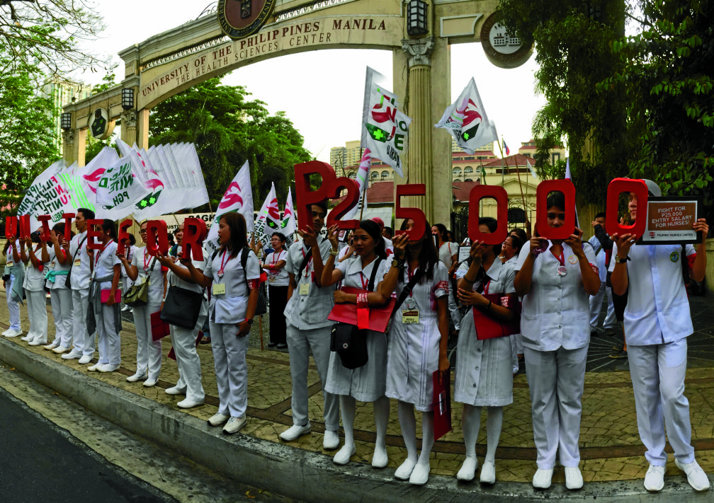 SICK OF LOWWAGES Members of the FilipinoNurses United join a unity walk to the Philippine General Hospital on Taft Avenue in Manila to press the government to standardize their starting monthly pay at P25,000. The nurses will wind up their two-day congress today. ANNELLE TAYAO-JUEGO