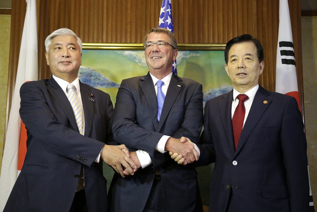 U.S. Defense Secretary Ash Carter, center, meets with Japan's Defense Minister Gen Nakatani, left, and South Korea's Defense Minister Han Min-koo, right, during their trilateral meeting on the sidelines of the 15th International Institute for Strategic Studies Shangri-la Dialogue, or IISS, Asia Security Summit on Saturday, June 4, 2016, in Singapore. (AP Photo/Wong Maye-E)