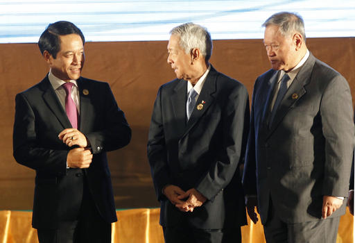 Laotian Foreign Minister Saleumxay Kommasith, left, talks to his counterpart Perfecto Yasay Jr. of the Philippines, center, and Brunei's Trade Minister Jock Seng Pehin Lim after the opening ceremony of the 49th Association of Southeast Asian Nations (ASEAN) Foreign Ministers' Meeting in Vientiane, Laos, Sunday, July 24, 2016. (AP Photo/Sakchai Lalit)