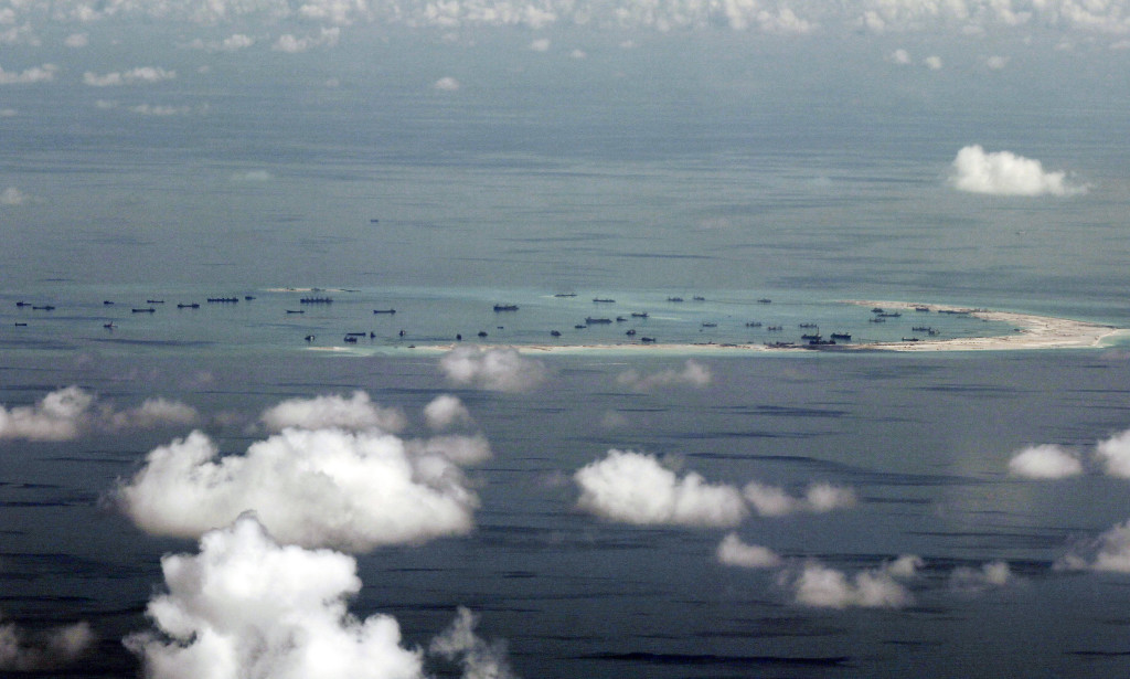 FILE - This May 11, 2015, file photo, shows land reclamation of Mischief Reef in the Spratly Islands in the South China Sea.  A landmark ruling on an arbitration case filed by the Philippines that seeks to strike down China's expansive territorial claims in the South China Sea will be a test for international law and world powers. China, which demands one-on-one talks to resolve the disputes, has boycotted the case and vowed to ignore the verdict, which will be handed down Tuesday, July 12, 2016,  by the U.N. tribunal in The Hague. (Ritchie B. Tongo/Pool Photo via AP, File)