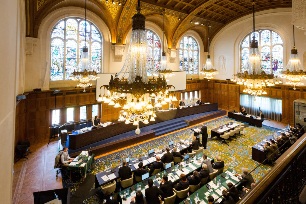 In this July 7, 2015, image provided by the Permanent Court of Arbitration, the case regarding the Philippines and China on the South China Sea is heard at the Permanent Court of Arbitration (PCA) at The Hague, the Netherlands.  An arbitration panel in The Hague, Netherlands, will issue a ruling Tuesday, July 12, 2016, in a long-running dispute between the Philippines and China over the South China Sea. The Philippines has asked the tribunal to declare China's claims and actions invalid under the U.N. Convention on the Law of the Sea. Beijing has refused to join the case, rejecting the tribunal's jurisdiction, and says it will not accept the decision.(Permanent Court of Arbitration via AP)
