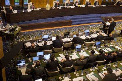 In this Nov. 24, 2015, image provided by the Permanent Court of Arbitration, a tribunal of five arbitrators, seated top right, hears the case regarding the Philippines and China on the South China Sea at the Permanent Court of Arbitration (PCA) at The Hague, the Netherlands. A landmark ruling on an arbitration case filed by the Philippines that seeks to strike down China's expansive territorial claims in the South China Sea will be a test for international law and world powers. China, which demands one-on-one talks to resolve the disputes, has boycotted the case and vowed to ignore the verdict, which will be handed down Tuesday, July 12, 2016, by the U.N. tribunal in The Hague.(Permanent Court of Arbitration via AP)