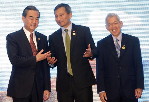 Chinese Foreign Minister Wang Yi, left, talks to Singapore's Foreign Minister Vivian Balakrishnan, center, and Philippine Foreign Secretary Perfecto Yasay, during the Association of Southeast Asian Nations (ASEAN) –China Foreign Ministers' Meeting in Vientiane, Laos, Monday, July 25, 2016. A highly anticipated meeting between Southeast Asian foreign ministers and their Chinese counterpart Wang Yi has begun in what is expected to be tense discussions on China's territorial expansion in the South China Sea. AP
