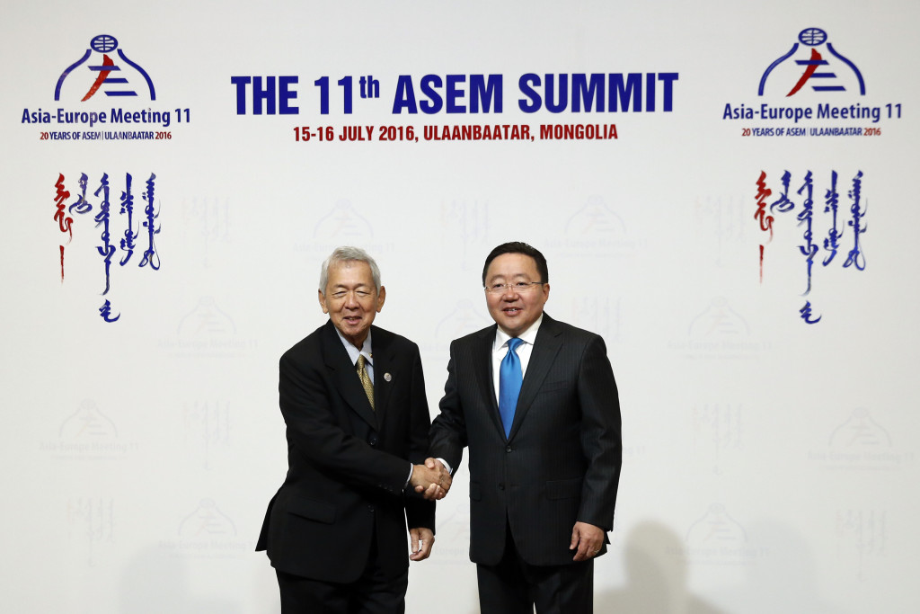 Philippine Foreign Affairs Secretary Perfecto Yasay Jr., left, is greeted by Mongolia's President Tsakhiagiin Elbegdorj, right, as he arrives for the 11th Asia-Europe Meeting (ASEM) in Ulaanbaatar, Mongolia, Friday, July 15, 2016. (AP Photo/Mark Schiefelbein, Pool)