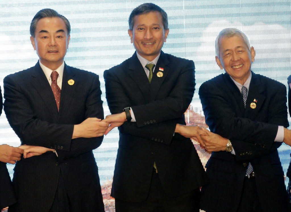Chinese Foreign Minister Wang Yi, left, Singapore's Foreign Minister Vivian Balakrishnan, center, and Philippine Foreign Secretary Perfecto Yasay Jr., pose for a photo during the Association of Southeast Asian Nations (ASEAN) – China Foreign Ministers' Meeting in Vientiane, Laos, Monday, July 25, 2016.  A highly anticipated meeting between Southeast Asian foreign ministers and their Chinese counterpart Wang Yi has begun in what is expected to be tense discussions on China's territorial expansion in the South China Sea.  (AP Photo/Sakchai Lalit)