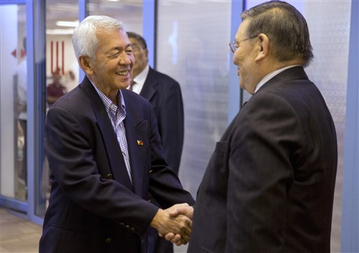 Philippine Foreign Affairs Secretary Perfecto Yasay Jr., left, shakes hands with Mongolia's past vice minister of foreign affairs Choinkhor, right, as he arrives at Chinggis Khaan International Airport ahead of the ASEM summit in Ulaanbaatar, Mongolia Thursday, July 14, 2016. (AP Photo/Mark Schiefelbein, Pool)