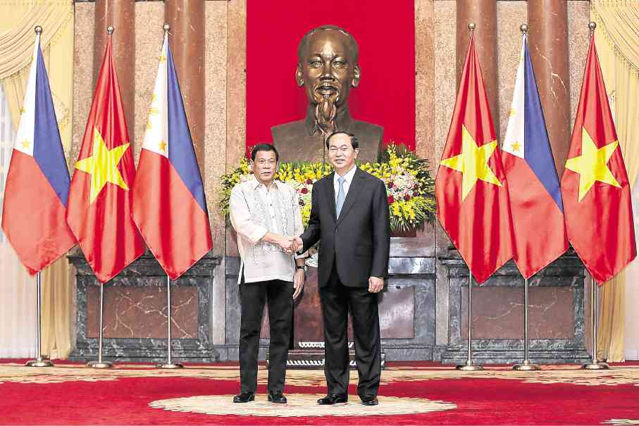 OFFICIAL VISIT President Duterte meets with Vietnamese President Tran Dai Quang at the Presidential Palace in Hanoi. The Philippine leader, who is on a two-day official visit to Vietnam, announced that next month’s US-Philippine military exercises would be the last and that there would be no joint navy patrols in the South China Sea. AFP