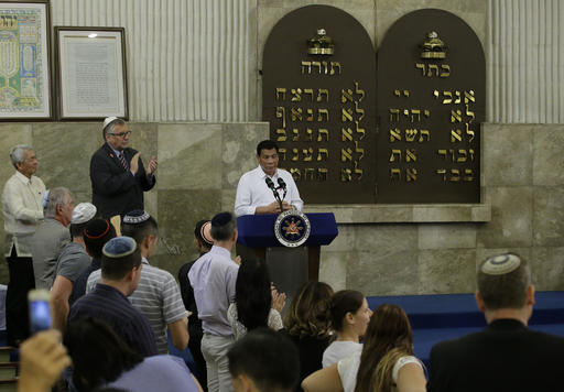 Philippine President Rodrigo Duterte is applauded after his speech at the Beit Yaacov Synagogue, The Jewish Association of the Philippines in Makati, south of Manila, Philippines on Tuesday, Oct. 4, 2016. Duterte has apologized to Jews worldwide after his remarks drawing comparisons between his bloody anti-drug war and Hitler and the Holocaust sparked shock and outrage. (AP Photo/Aaron Favila, Pool)