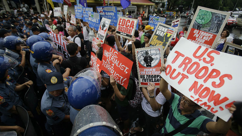 EMBASSY RALLY Policemen block protesters trying to get near the US Embassy during a rally against the Enhanced Defense Cooperation Agreement between the United States and the Philippines. AP