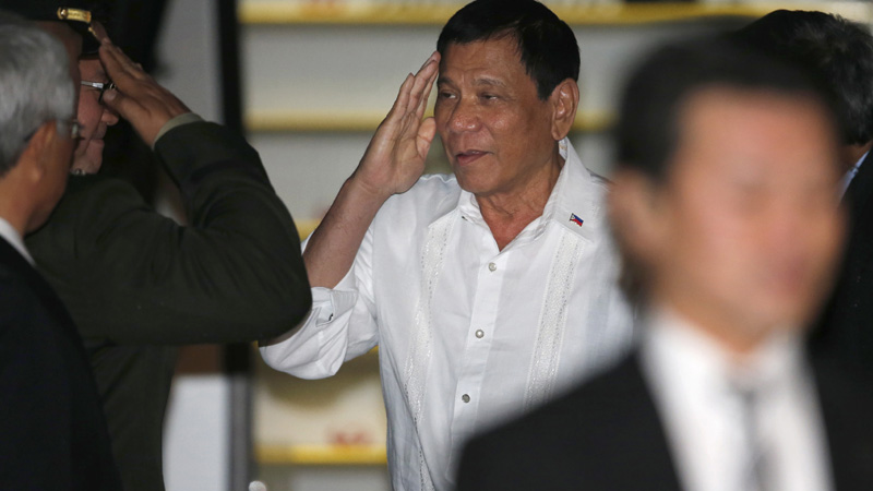 Philippine President Rodrigo Duterte, center, arrives at Haneda international airport in Tokyo, Tuesday, Oct. 25, 2016. Duterte is on a three-day official visit to Japan. (AP Photo/Shuji Kajiyama)