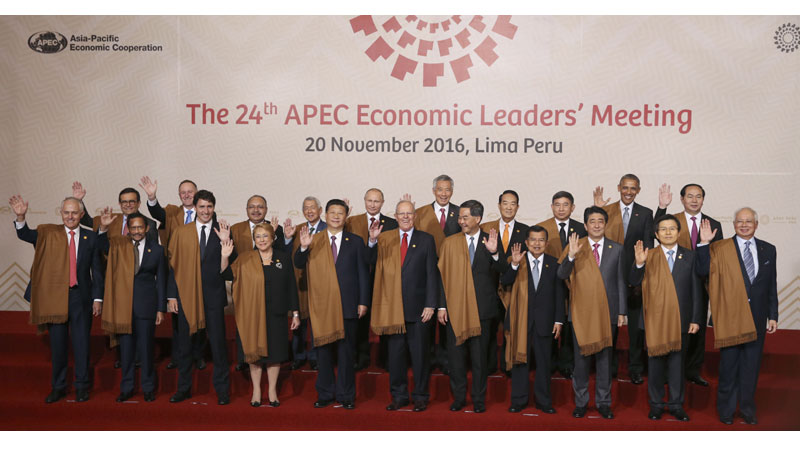 Leaders of Asia Pacific Economic Cooperation, APEC, wave during the group photo in Lima, Peru, Sunday, Nov. 20, 2016. Front row, from left: Australia's Prime Minister Malcolm Turnbull, Brunei's Sultan Hassanal Bolkiah, Canada's Prime Minister Justin Trudeau, Chile's President Michelle Bachelet, China's President Xi Jinping, Peru's President Pedro Kuczynski, Hong Kong's Chief Executive Leung Chun-ying, Indonesia's Vice President Jusuf Kalla, Japan's Prime Minister Shinzo Abe, South Korea's Prime Minister Hwang Kyo-ahn and Malaysia's Prime Minister Najib Razak. Back row, from left: Mexico's Secretary of Economy Ildefonso Guajardo, New Zealand's Prime Minister John Key, Papua New Guinea's Prime Minister Peter O'Neill, Philippines's Secretary of Department of Foreign Affairs Perfecto Yasay, Russia's President Vladimir Putin, Singapore's Prime Minister Lee Hsien Loong, Taiwan 's special APEC envoy James Soong, Thailand's Deputy Prime Minister Prajin Juntong, US President Barack Obama and Vietnam's President Tran Dai Quang. (AP Photo/Martin Mejia)