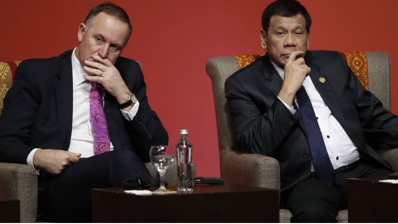 New Zealand's Prime Minister John Key, left, and Philippines' President Rodrigo Duterte, attend a meeting with business leaders during the annual Asia Pacific Economic Cooperation, APEC, Summit in Lima, Peru, Saturday, Nov. 19, 2016. (AP Photo/Martin Mejia)