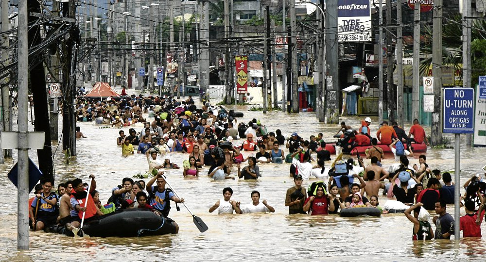 Rescuers ferry stranded residents from their houses due to floods caused by Tropical Storm Ondoy along Ortigas in Cainta Rizal in September 2009. Nearly 60 people were killed, Manila was blacked out and airline flights were suspended as a powerful storm battered the main Philippines island of Luzon on a weekend, disaster officials said.   INQUIRER PHOTO/EDWIN BACASMAS