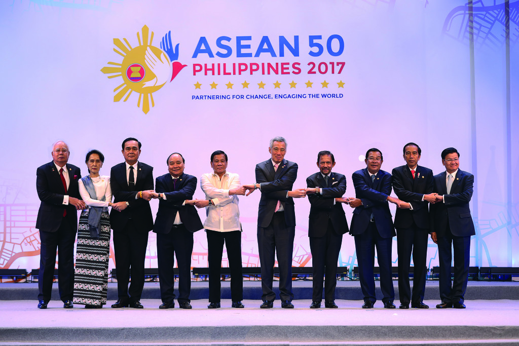 Leaders of the Association of Southeast Asian Nations (ASEAN) link arms in the iconic ASEAN way during the 30th ASEAN Summit Opening Ceremony at the Philippine International Convention Center on April 29. (L-R) Malaysian Prime Minister Dato Sri Mohd Najib Bin Tun Abdul Razak; State Counsellor for Myanmar  Aung San Suu Kyi; Thai Prime Minister General Prayut Chan-o-cha; Vietnam Prime Minister Nguyen Xuan Phuc;  Philippine President Rodrigo Roa Duterte; Singaporean Prime Minister Lee Hsien Loong; Brunei Sultan Haji Hassanal Bolkiah; Cambodian Prime Minister Hun Sen; Indonesian President Joko Widodo; and Lao Prime Minister Thongloun Sisoulith. Photo from DFA
