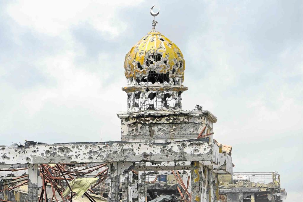 WAR-DAMAGED A bombed-out mosque stands in what was once the scene of intense fighting between government troops and Islamic State supporters in Marawi City. The military brought journalists to the area on Tuesday. —AFP