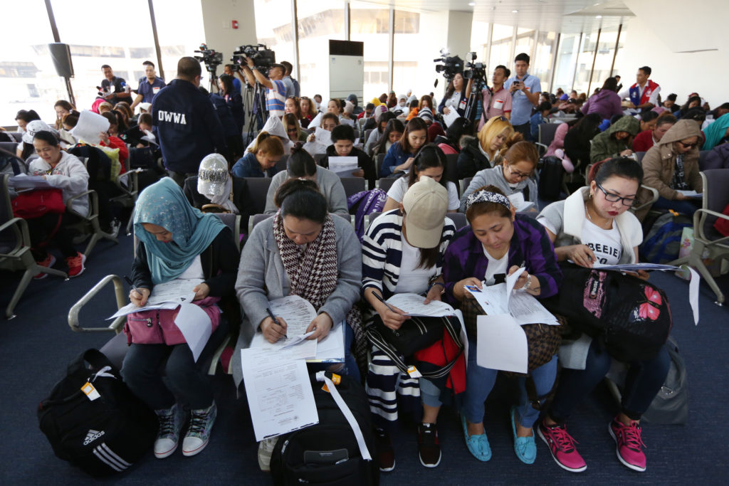 A batch of OFWs repatriated from Kuwait arrives at Ninoy Aquino International Airport on Feb. 12.— NIÑO JESUS ORBETA