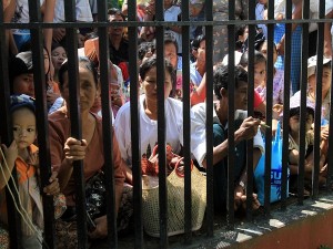 Family members of Myanmar prisoners wait outside Insein Prison in Yangon, Myanmar, Wednesday. Myanmar freed an outspoken critic and a major ethnic rebel as it began releasing 6,300 convicts Wednesday in its latest liberalizing move, but kept several political detainees behind bars, dampening hopes for a broader amnesty. AP