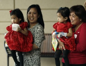 Angelina Sabuco, at left, is held by her mother Ginady Sabuco and twin sister Angelica, is held by aunt Marita Sabuco, at Lucile Packard Children's Hospital, Monday, Nov. 14, 2011 in Stanford, Calif. The twin sisters, who were born joined in the chest an abdomen, are preparing to go home after an intricate surgery by a group of Lucile Packard doctors to separate them. (AP Photo/Marcio Jose Sanchez)