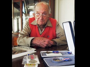 Tom Harrison, 93, displays his World War II medals at his home in Salt Lake City on Sunday. He received seven medals, including the Distinguished Service Cross and the Silver Star, six decades later. AP Photo