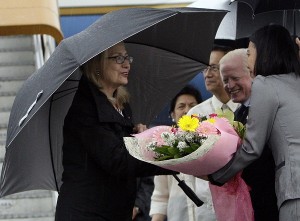 U.S. Secretary of State Hillary Clinton receives a bouquet upon arrival Tuesday, Nov. 15, 2011 in Manila, Phillippines. Clinton will be in the country to commemorate the 60th anniversary of the signing of the Philippines-U.S. Mutual Defense Treaty and to launch the Partnership for Growth and as part of the administration of President Barack Obama's thrust to reaffirm and broaden alliances and partnerships in the Asia-Pacific. Others in photo are Philippine Ambassador to the U.S. Jose Cuisia Jr second right and Undersecretary of Foreign Affairs Rafael Seguis third right. (AP Photo/Pat Roque)