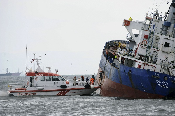 Coast guard members climb into the tilting Sierra Leone-flagged Kayan-1, a 282-feet freighter carrying empty containers, as crew pumped out water, and a tugboat stands by , in the Bosporus, Istanbul, Turkey, Friday. AP Photo
