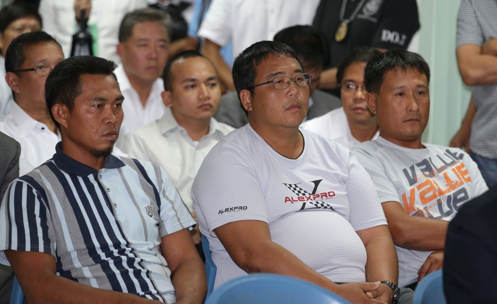 Fishermen Indonesian Imam Buchaeri, left, Taiwanese Hong Jie Shang, center, and Hong Yu Zhi, right, listen during the start of a hearing at the Philippine Department of Justice in Manila sometime in May, 2014.  AP FILE PHOTO