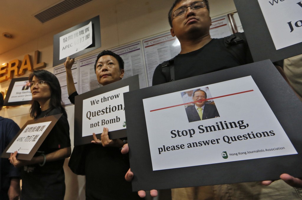 Members of Hong Kong Journalists Association hold placards during a protest at the Philippines Consulate in Hong Kong, Tuesday, Oct. 8, 2013. The association is protesting the treatment of Hong Kong reporters covering a regional economic summit in Indonesia, saying they were treated like a serious security threat by the organizers who barred them from the event after they shouted questions at Philippine President Benigno Aquino III, who was only willing to convey an expression of regret but not the apology that Hong Kong Chief Executive Leung Chunying wanted.  AP FILE PHOTO