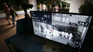 Passengers walk past a thermal scanner at the medical quarantine area at the arrival section of Manila's International Airport in Paranaque, south of Manila, Philippines. AP FILE PHOTO