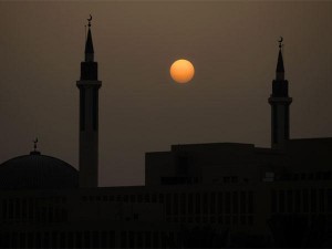 The sun sets behind a mosque in Riyadh, Saudi Arabia. AP file photo