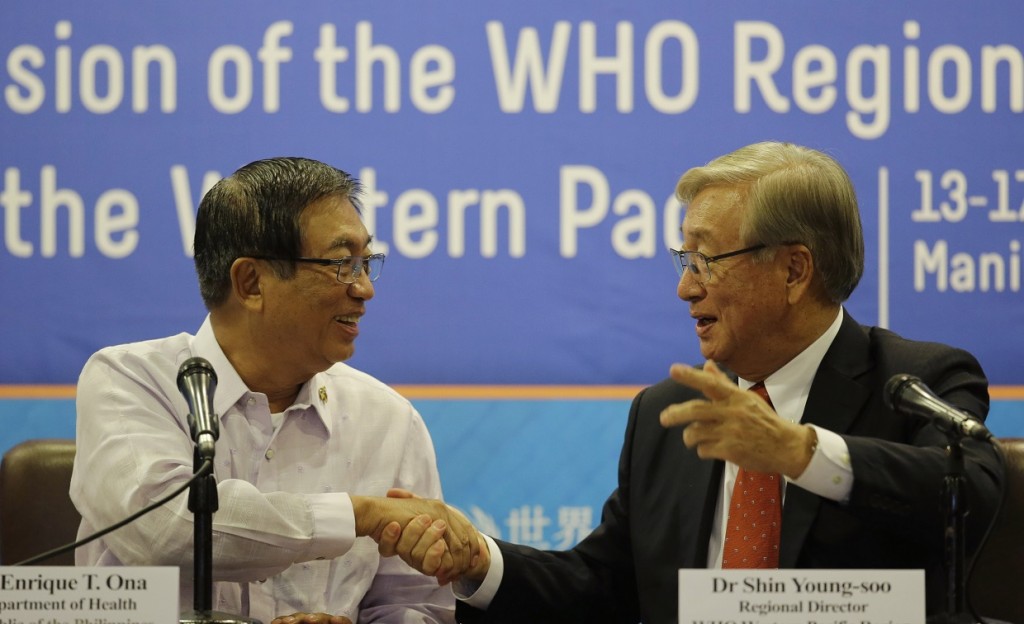 WHO Asia Pacific Region Regional Director Shin Young-soo, right, and  Health Secretary Enrique Ona shake hands following a joint news conference ahead of the next week's 65th WHO Regional Conference Friday in Pasay City. AP