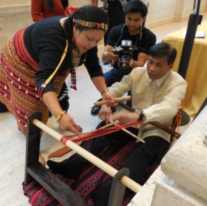 Consul General Bensurto tries his hand at weaving a traditional Kalinga cloth.