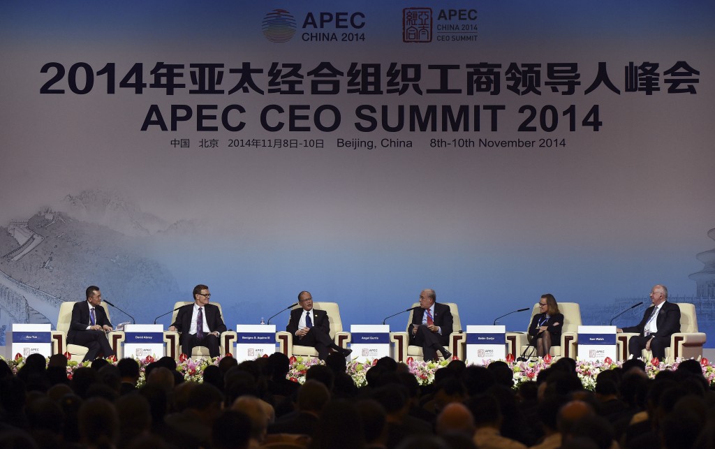 From left, CCTV anchor Zoe Yue; David Abney, CEO of UPS; Philippine President Benigno Aquino III; Angel Gurria, secretary-general of the Organization for Economic Cooperation and Development; Belen Garijo, president and CEO of Merck Serono; and Sam Walsh, chief executive for Rio Tinto take part in a summit dialogue at the APEC CEO Summit at the China National Convention Center in Beijing, China Sunday, Nov. 9, 2014, as part of the Asia-Pacific Economic Cooperation summit.  AP PHOTO/WANG ZHAO, POOL