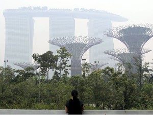 This photo taken on Monday, June 17, 2013 shows the Marina Bay Sands hotel and the Supertrees at Gardens By The Bay covered in haze.  AP FILE PHOTO