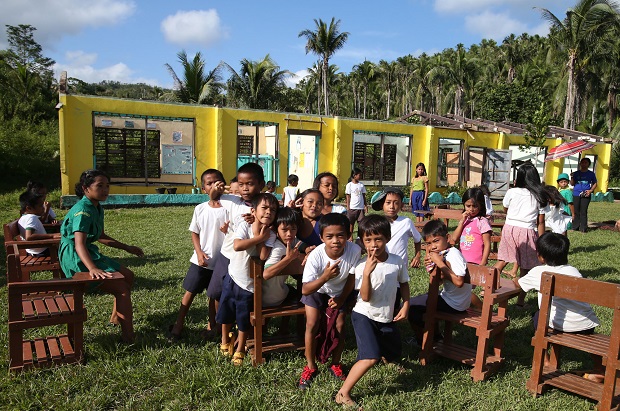 NOVEMBER 05, 2014 Primary and Elementary pupils gather outside their temporary school room tent near their school building destroyed by Supertyphoon Yolanda  in Barangay Cancueves, Mc Arthur, Eastern Samar. The school building is under repair project funded by UNICEF and  Action contre la Faim. EDWIN BACASMAS
