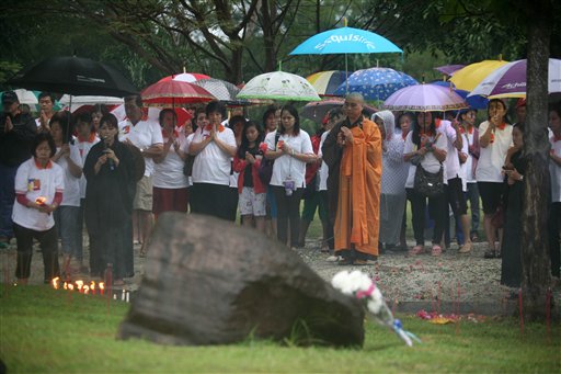 Indonesian Buddhists pray for the victims of Indian Ocean tsunami one day ahead of its 10th anniversary at a mass grave in Banda Aceh, Aceh province, Indonesia, Thursday, Dec. 25, 2014. AP