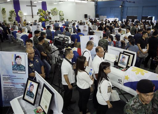 Mourners pay their last respects to the 44 police anti-terror commandos who perished  last Sunday during the Philippines' biggest single-day combat loss in recent years,  at Camp Bagong Diwa, Taguig city, south of Manila, Philippines, on Friday, Jan. 30, 2015. AP 
